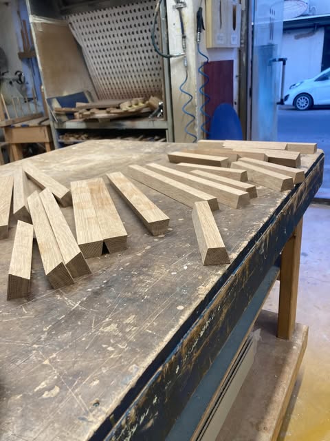 Wood pieces arranged on a workbench in a workshop.