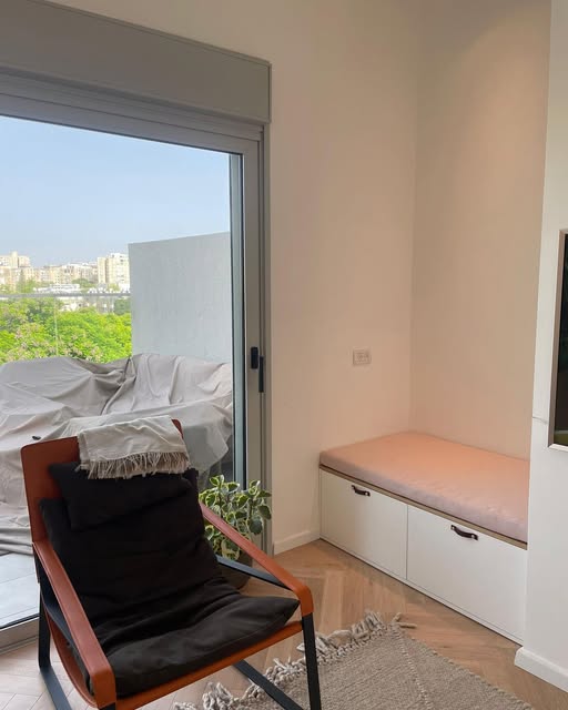 Storage below a window seat with a wood-toned top.