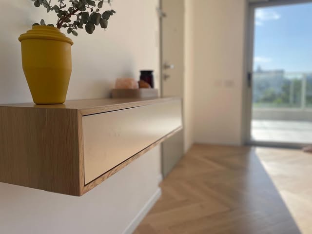 Wall-mounted cabinet with white doors and wood-toned sections.